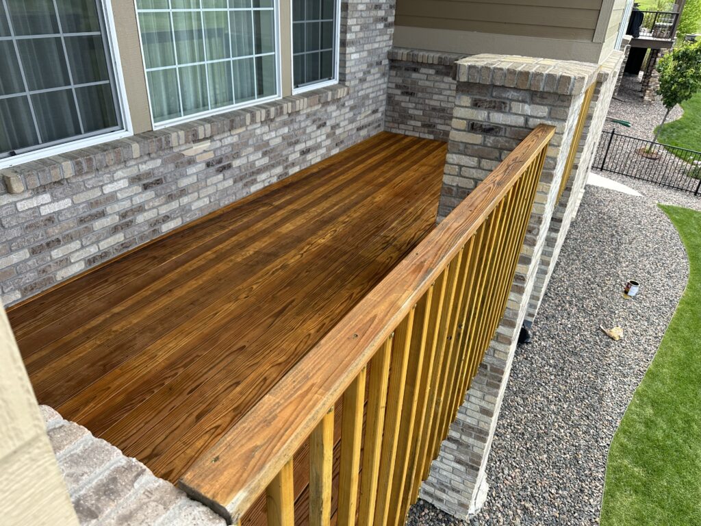 A natural wood deck stained with clear coat