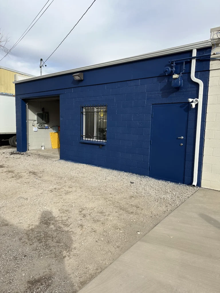 Updated business exterior cinderblock with fresh blue paint