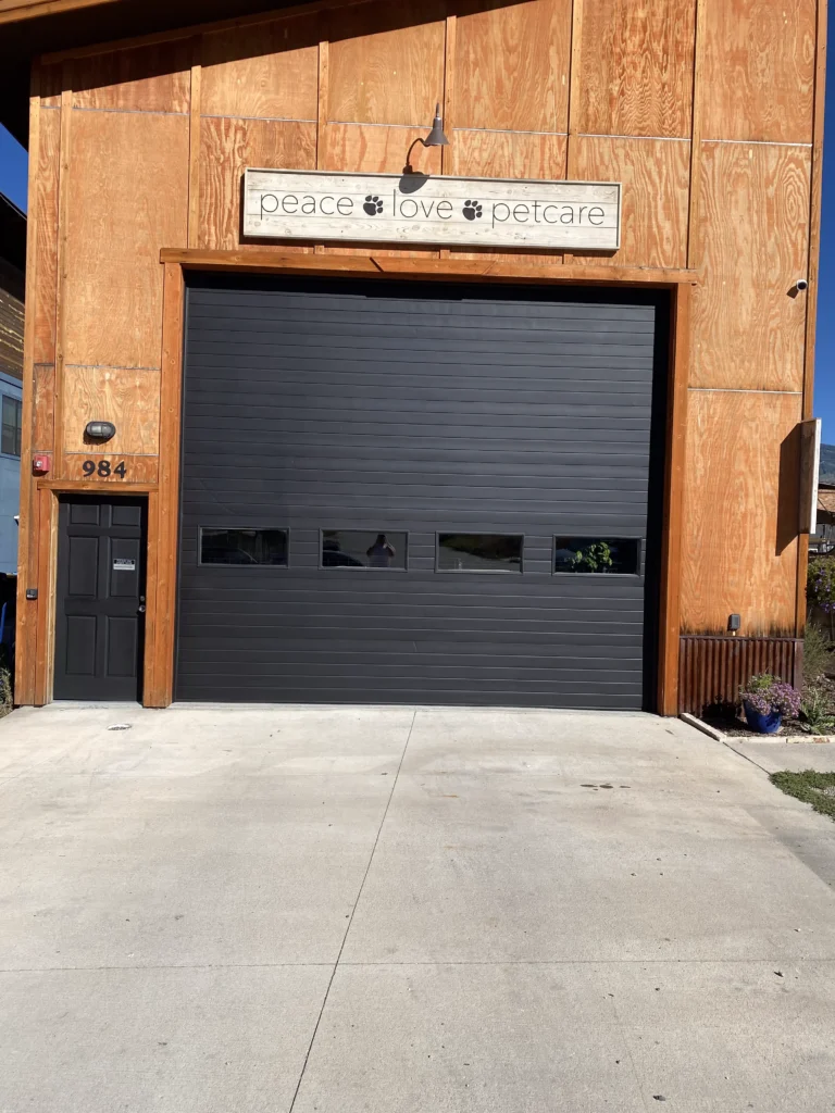 Dark gray business garage door paint with matching entrance